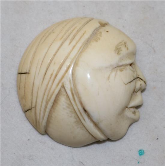 A Japanese ivory netsuke of a reclining man and an ivory mask, possibly Hotei, 19th/early 20th century, 3.9cm and 3.6cm